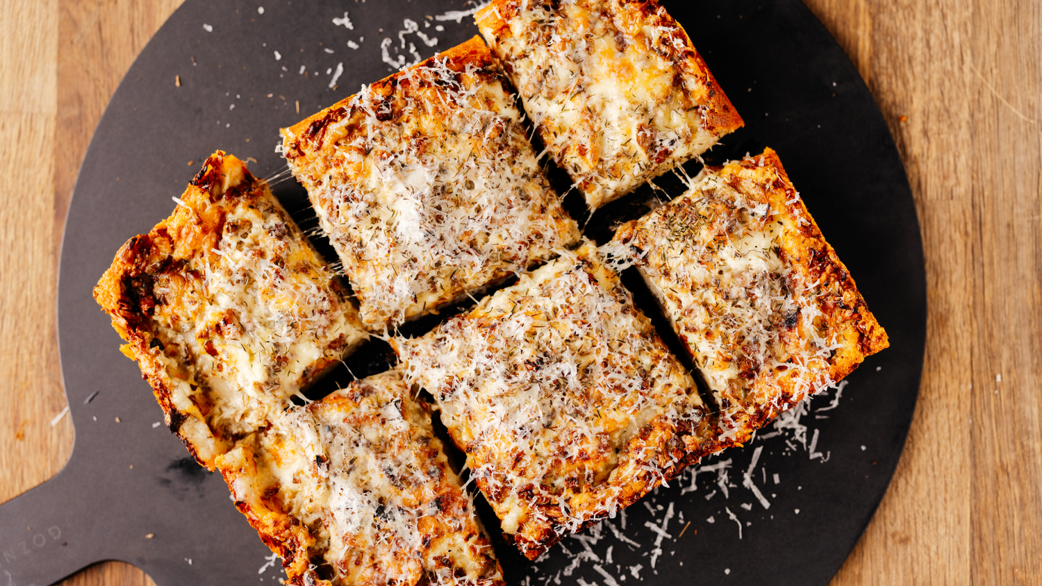 Mushroom Detroit Style Pizza Cut into 6 slices on Gozney Pizza Server