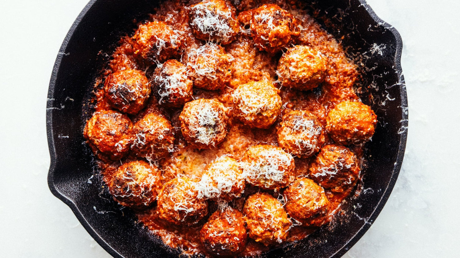Wood-Fired meatballs in a cast iron skillet.